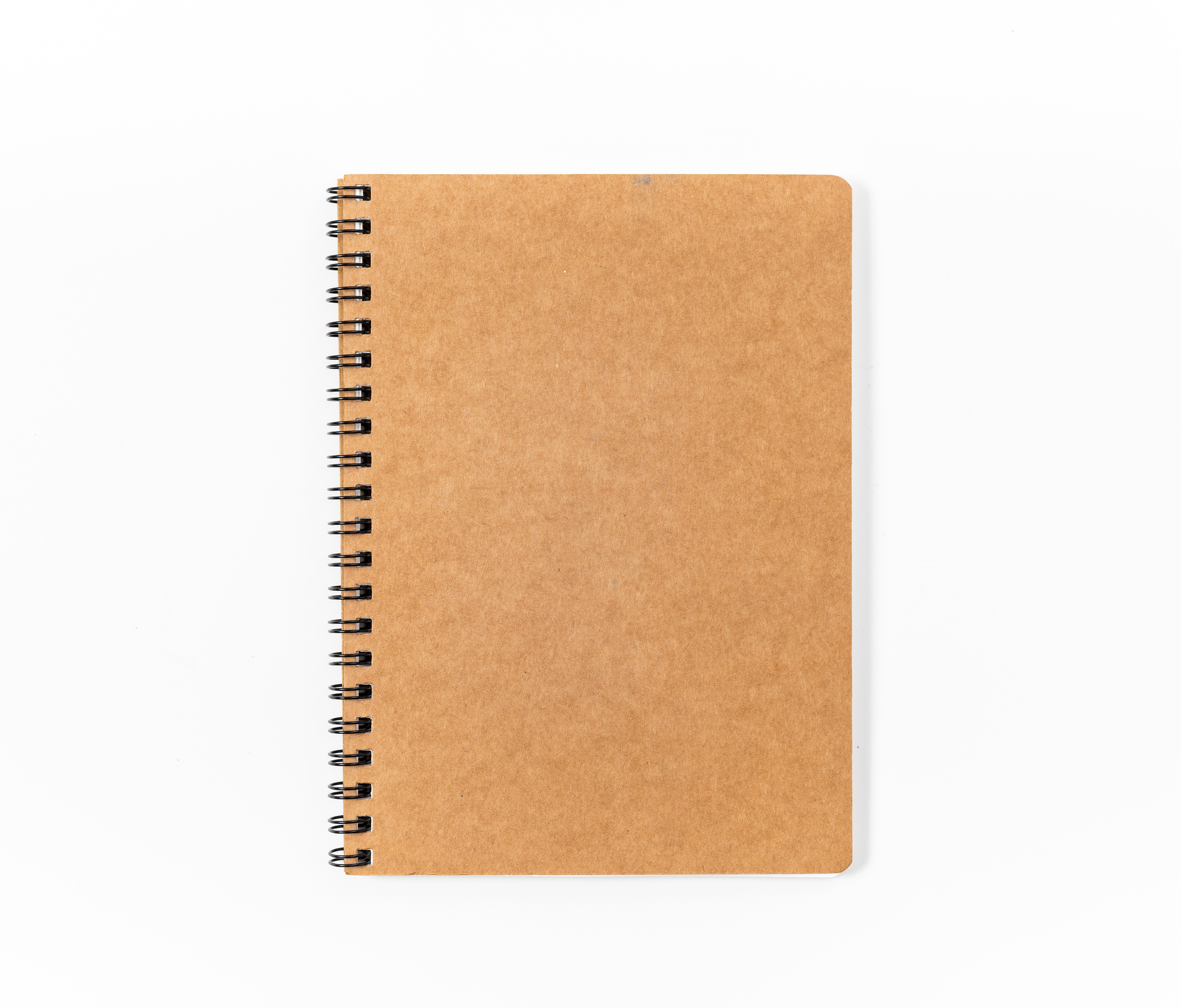 Brown spiral notebook isolated on white background.top view